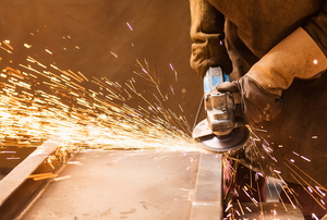 using an angle grinder with flying sparks