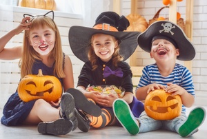 Kids with Halloween pumpkins.