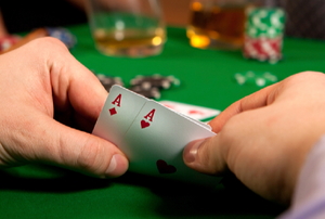 hand of cards at a poker table