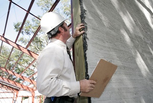 A man works on a wall.