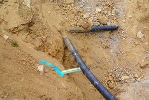 Sprinkler pipe in a trench.