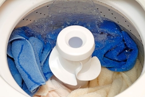 open washing machine washing colored clothing