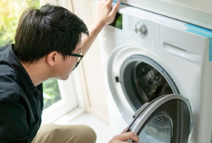 A man looks at a dryer.