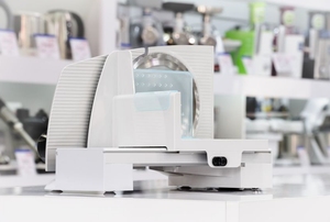 white, clean meat and cheese slicer sitting on counter
