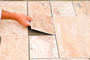 Worker Placing Final Floor Tile