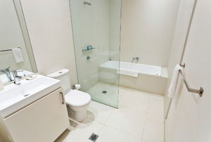 a white bathroom with glass shower doors
