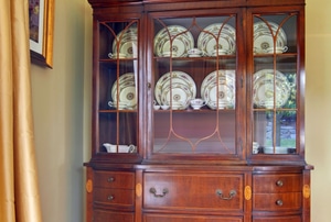 China hutch in the corner of a room