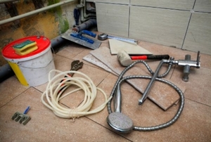 Tools and materials standing by for a bathroom remodel.