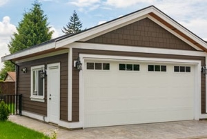 freestanding garage with peak roof and white door
