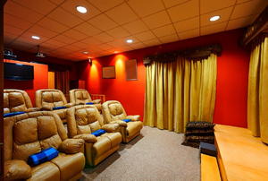 A home theater room with large, leather chairs.