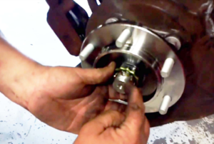 man working on a wheel bearing