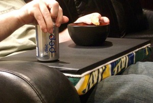 A man using a lap tray in his man cave.