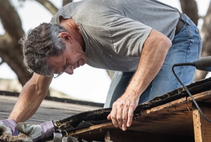 man repairing roof