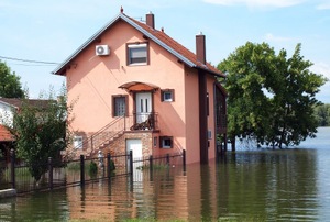 A pink house surrounded by floodwaters.