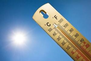 A thermometer with the sun in the background.