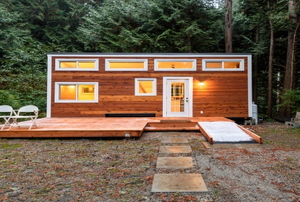 A modern tiny built with proper city codes home in a forest.