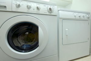 A white dryer sitting in a laundry room.