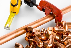 Copper pipe, a pipe cutter, and copper fittings.