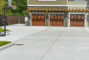 a concrete driveway in front of a house