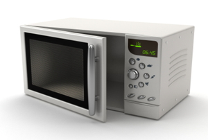 A white microwave with the door left slightly open.