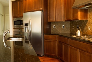 An updated kitchen with wood cabinets.