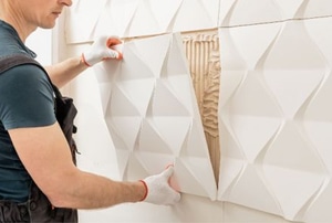 man installing wall panel