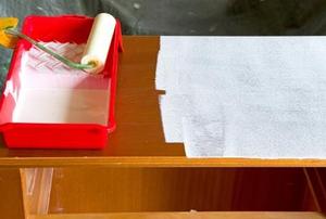 An old dresser getting a fresh coat of paint.