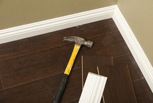 Baseboards with a hammer on it