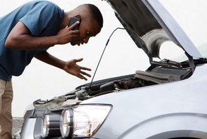 a person looking into the hood of a car
