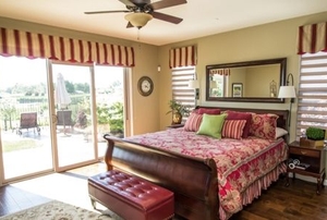 a bedroom with window valances