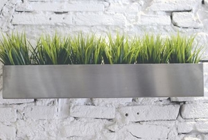 metal planter hanging in front of brick wall