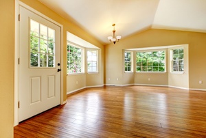 A wooden floor in a large room with lots of natural light.