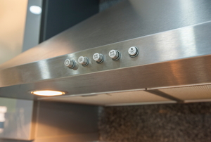A range hood over a stove with a kitchen exhaust fan built in.
