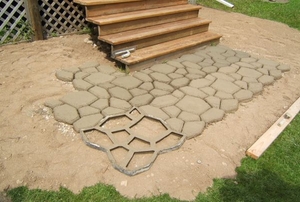 A decorative geometric pattern in a concrete pathway.