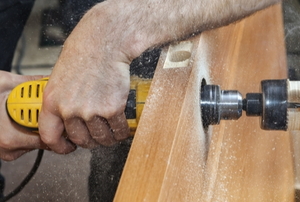 A man works on a saw table.