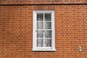 a window surrounded by brick