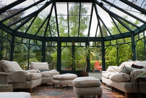 a sunroom with chairs and sofa