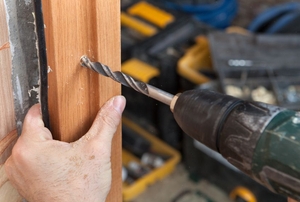 Drilling through a door jamb into a frame.