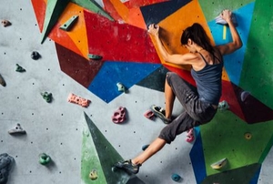 woman climbing wall with protruding surfaces