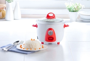 A white and orange rice cooker.