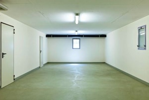 basement with white walls and concrete floor