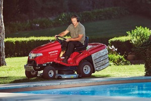 A man uses a lawnmower.