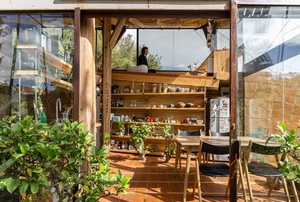 unique entryway into a glass house with terra cotta tile flooring