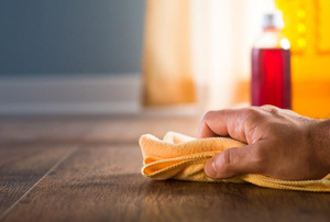 a hand with a cloth on a counter