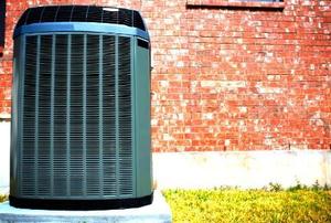 A high-efficiency, modern AC unit in front of a brick wall.