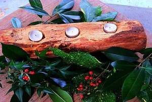 A log transformed into a holiday candle holder.