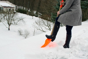 A woman shoveling snow.