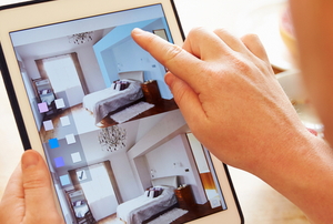 person using tablet with room design app, comparing colors for a bedroom wall
