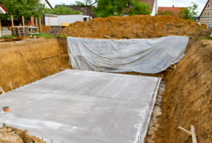 The beginning stages of house construction with a basement foundation.