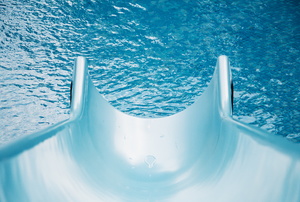 A slide leading to a pool.